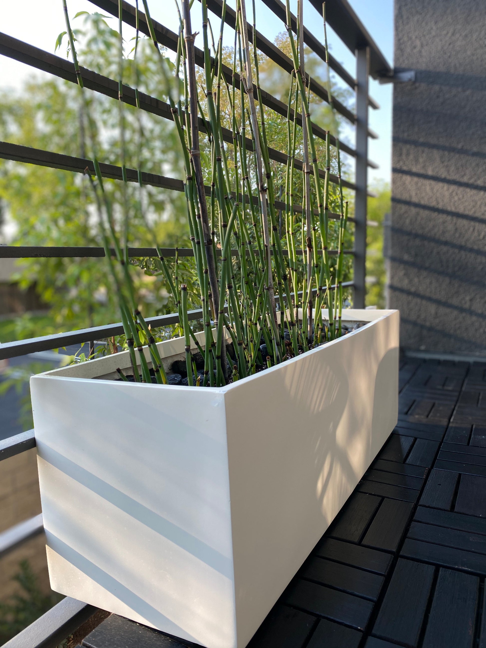 White Belmont Rectangle Fiberglass Planter Box by patio deck