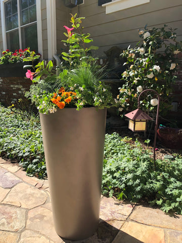 https://www.rootandstockco.com/cdn/shop/products/Root_and_Stock_Sonoma_Grey_Round_Tall_Planter_4_large.jpg?v=1678136024